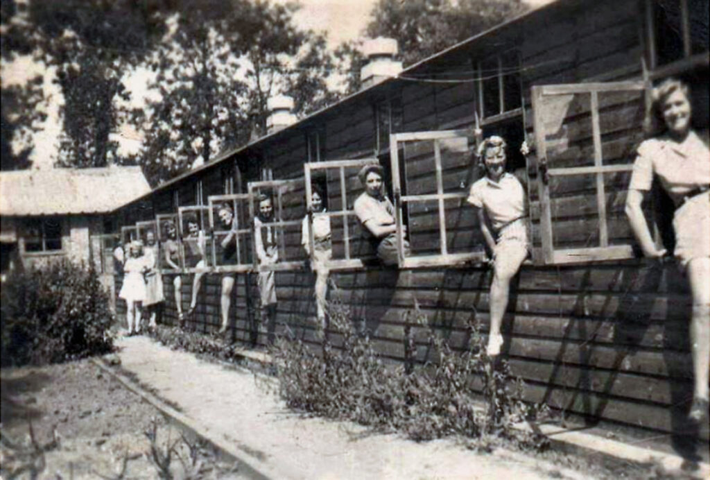 women at the windows of a long building