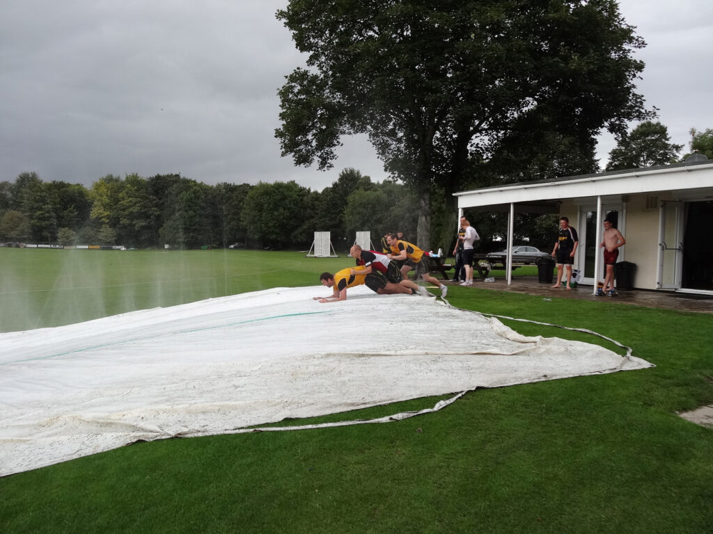 tarpaulin on grass with water spraying on it