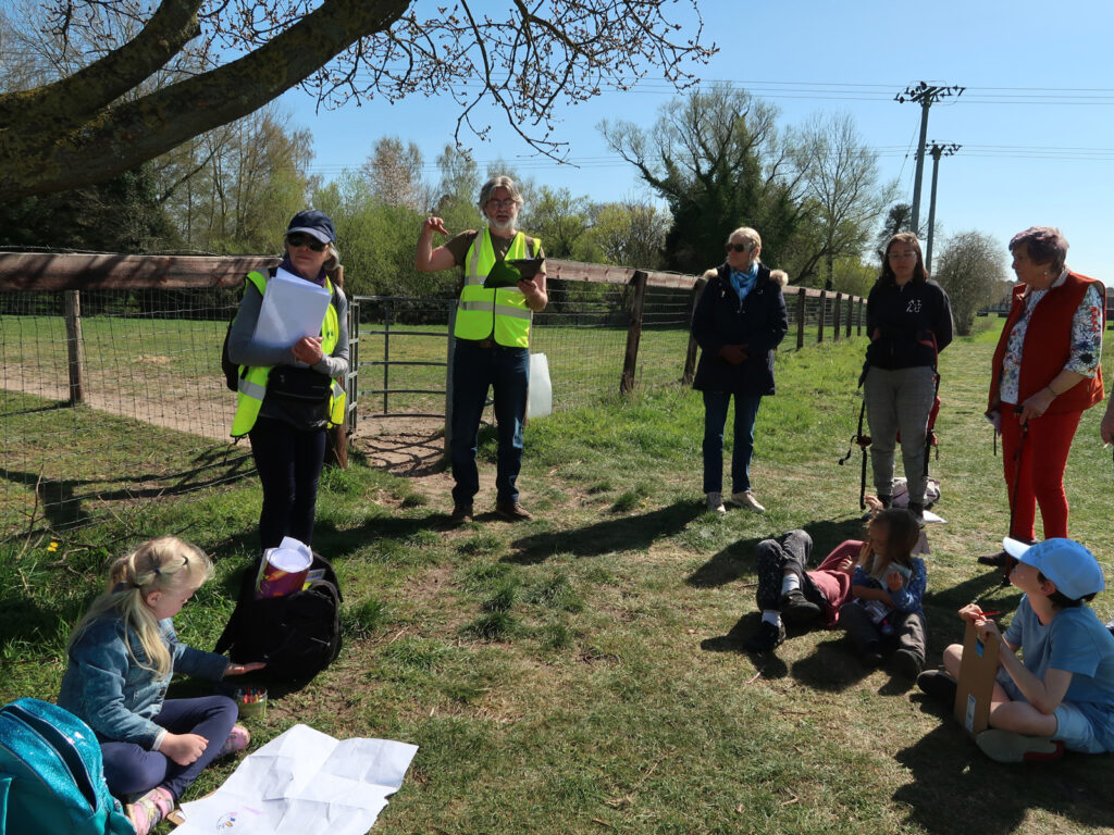 volunteer with walk participants on Staunch Meadow