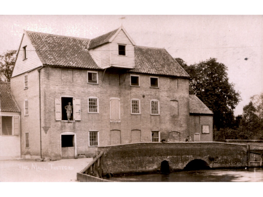 Thetford Coffee Mill, when a corn mill, about 1900, man standing in first floor open doorway, mill pool in front