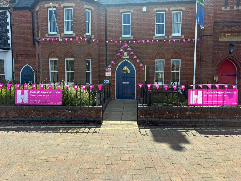 front of Brandon Town Council building with pink HODs banners
