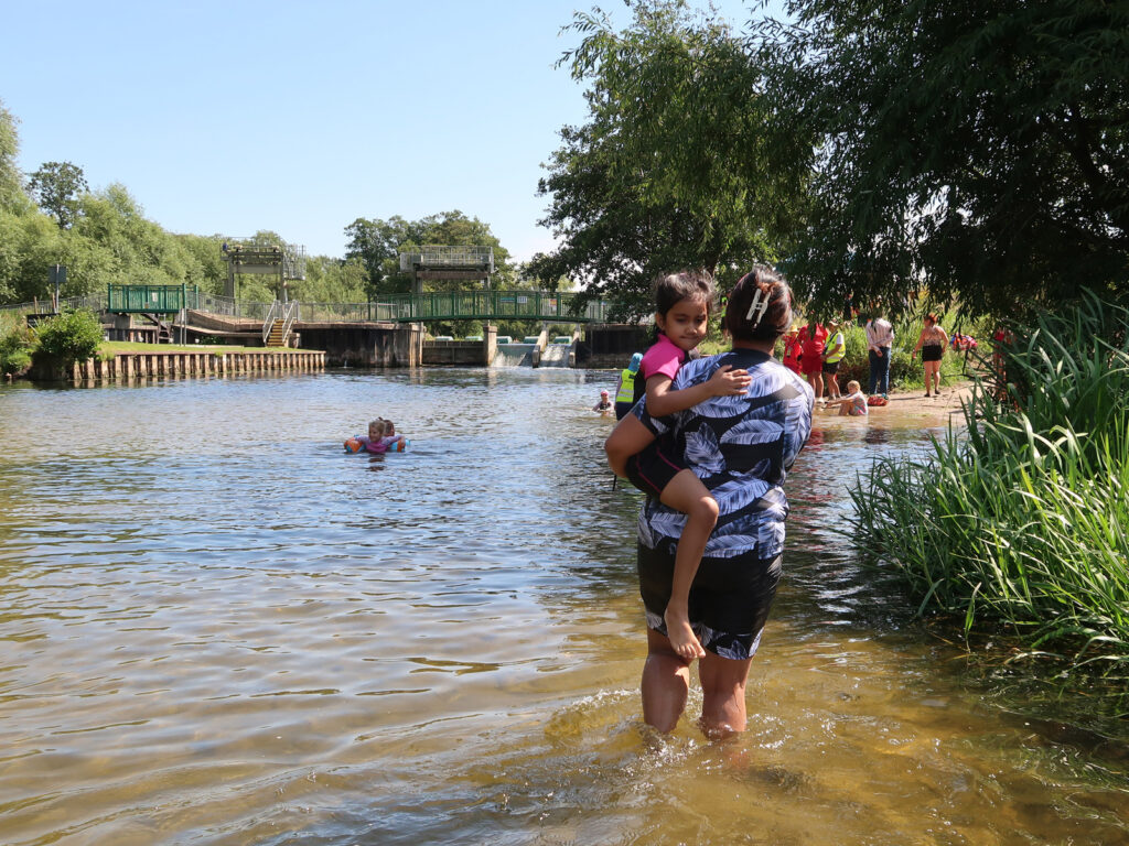 families and children in the water, with volunteer and lifeguards at intro session Brandon Staunch