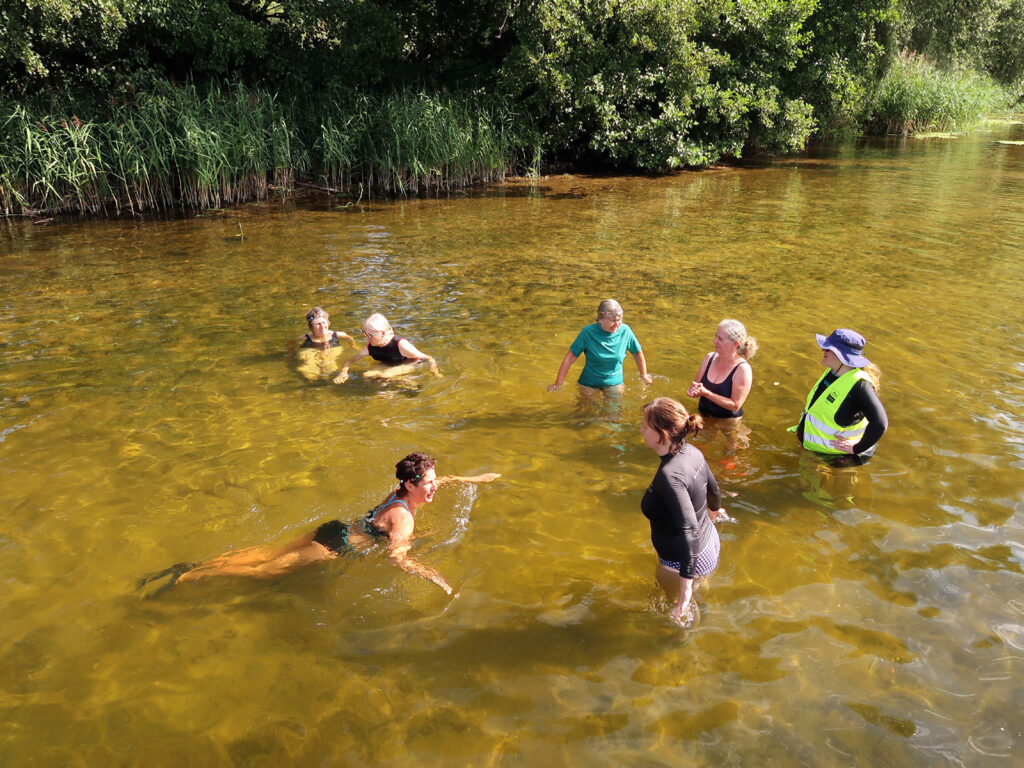 swimmers in the water with volunteer at intro session Brandon Staunch 9 August